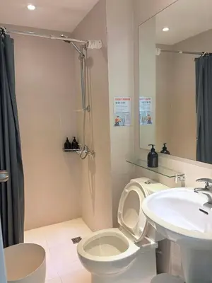 a bathroom with a toilet and a sink at 1 bedroom at Azure Urban Resort Condo in Manila