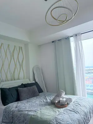 a bedroom with a bed with a large window at 1 bedroom at Azure Urban Resort Condo in Manila