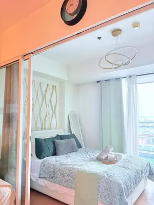 a bedroom with a bed with an orange ceiling at 1 bedroom at Azure Urban Resort Condo in Manila