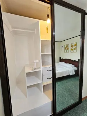 a mirror in a room with a bed and a bedroom at Cozy Bian Getaway - Entire House for Rent in Biñan