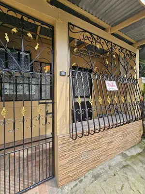 a wrought iron gate on a building at Cozy Bian Getaway - Entire House for Rent in Biñan