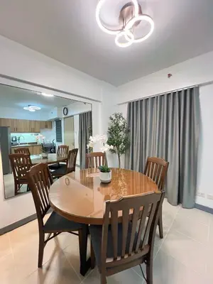 a dining room with a wooden table and chairs at Raya and Zane in Manila