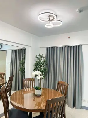a dining room with a wooden table and chairs at Raya and Zane in Manila