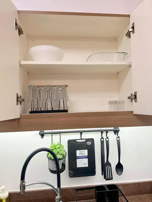 a kitchen counter with a sink and utensils at Raya and Zane in Manila