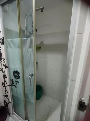 a shower with a glass door in a bathroom at Sea Residences Near MOA SMX Pasay City in Manila
