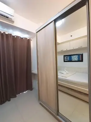 a room with a sliding glass door and a bedroom at Sea Residences Near MOA SMX Pasay City in Manila