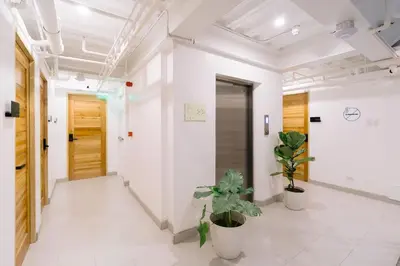 a corridor of an office with potted plants at Canopy Agutaya BGC in Manila