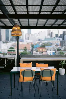 a table and chairs on a balcony with a view at Canopy Agutaya BGC in Manila