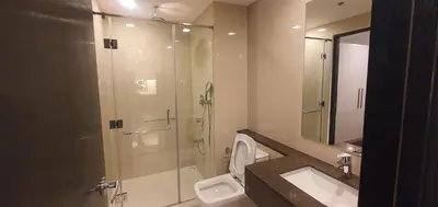 a bathroom with a shower and a toilet and a sink at Condotels by Irene in Manila