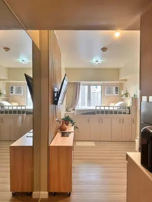 a large room with a kitchen with two beds at Condotels by Irene in Manila
