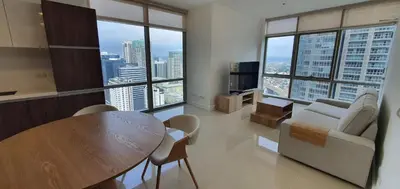 a living room with a table and a couch at Condotels by Irene in Manila