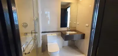 a bathroom with a toilet and a sink and a mirror at Condotels by Irene in Manila