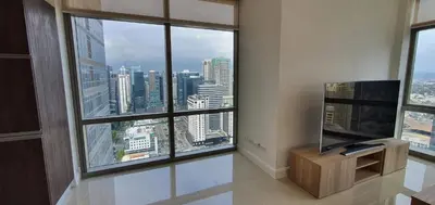 a living room with a large window with a television at Condotels by Irene in Manila