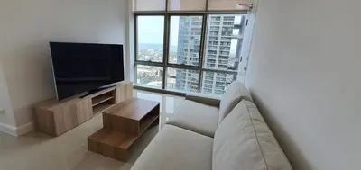 a living room with a couch and a flat screen tv at Condotels by Irene in Manila