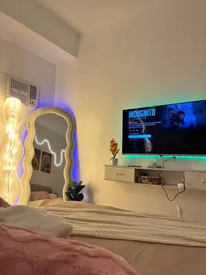 a bedroom with a bed with a tv and a bed at Sweetluxx - SMDC Green 2 Residences Staycation in Dasmariñas