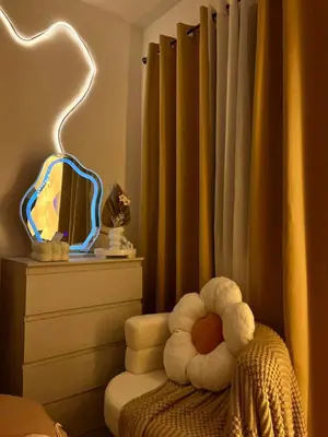 a bedroom with a mirror and a chair with a stuffed animal at Sweetluxx - SMDC Green 2 Residences Staycation in Dasmariñas