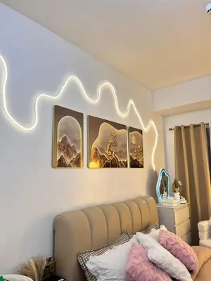 a living room with a couch and some pictures on the wall at Sweetluxx - SMDC Green 2 Residences Staycation in Dasmariñas