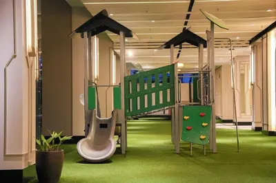 a childrens play area with a slide and a playground at Stylish Condo - Cozy Urban Living in Manila