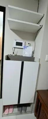 a shelf with a computer on top of it at Cozy Modern 2 Bedroom 81 Newport Boulevard in Manila
