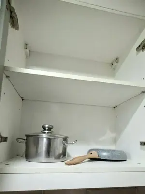 a pot and a pan on a shelf in a kitchen at Cozy Modern 2 Bedroom 81 Newport Boulevard in Manila