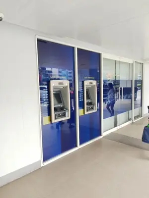 a bathroom with glass doors with a woman in a city at Josh place Shell residence MOA in Manila