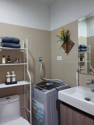 a bathroom with a sink and a toilet and a sink at Wowstaycation in Manila