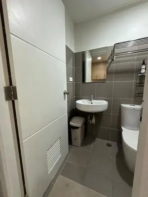 a bathroom with a toilet and a sink at Prime Salcedo Square Studio 2 Beds in Manila