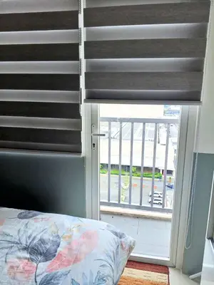 a bedroom with a window with a blind at Haute Haven - 1br with Balcony in Manila