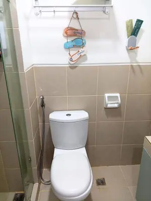 a bathroom with a toilet and a glass shower at Haute Haven - 1br with Balcony in Manila