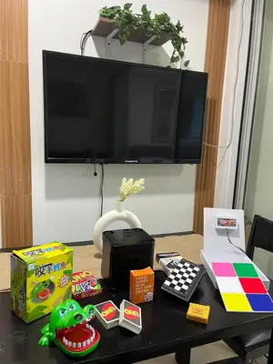 a table with toys on it with a tv at Cozy Corner By R&K in Manila