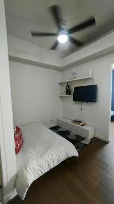 a bedroom with a bed and a flat screen tv at 2 Bedroom MEZZA RESIDENCES in Manila