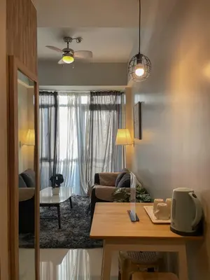 a living room with a couch and a table at Cozy Manhattan Araneta Cubao in Manila