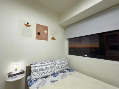 a bedroom with a bed and a window at AlRBNB Mandaluyong - by Jam Es in Manila