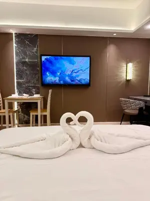 two white swans sitting on top of a bed at Canal View Luxury Stay, Studio type , Massage Chair, Office Desk in Manila