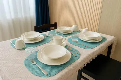 a table with plates and cups and dishes on it at SMDC BREEZE Manila Bay Sunset View in Manila