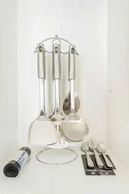 a group of wine glasses and utensils on a counter at SMDC BREEZE Manila Bay Sunset View in Manila