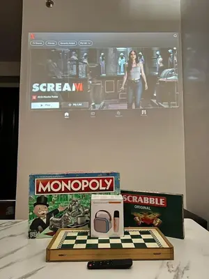 a box of monopoly and a game and a box of a computer at Cozy Condo for Relaxing Stays & Movie Nights in Imus