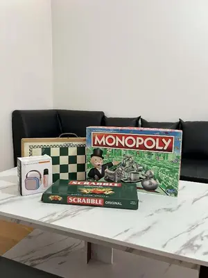 a table with a monopoly game on top of it at Cozy Condo for Relaxing Stays & Movie Nights in Imus