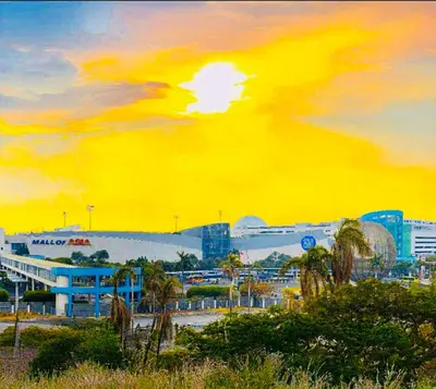 a painting of a city with a sunset at R E Staycations in Manila