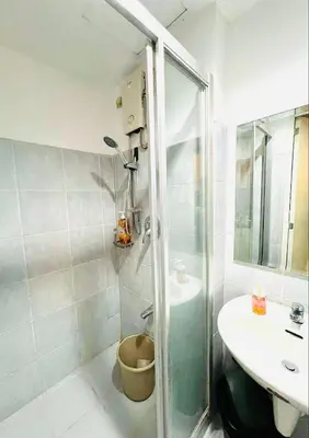 a bathroom with a shower and a sink at R E Staycations in Manila