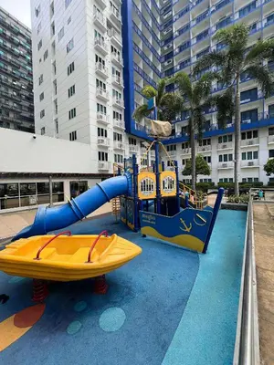 a water slide and a boat in a pool at R E Staycations in Manila