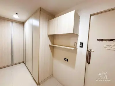 a room with a refrigerator and a door in it at R E Staycations in Manila