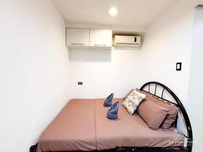 a small bedroom with a bed in a room at R E Staycations in Manila