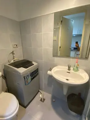 a bathroom with a toilet and a sink at Stern Home Stay at Sea Residences in Manila