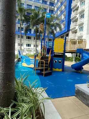 a playground in front of a apartment building at Stern Home Stay at Sea Residences in Manila