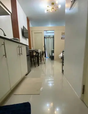 a kitchen and dining room with a ceiling fan at Stern Home Stay at Sea Residences in Manila