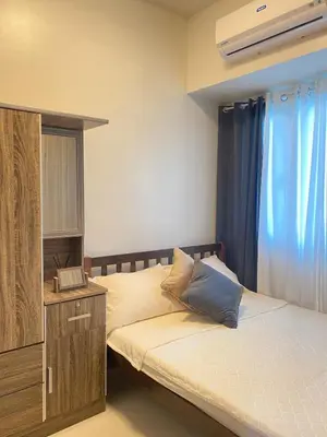 a bedroom with two beds and a dresser and a bed sidx sidx sidx sidx at 1BR Cozy Minimalist Unit near MOA or Manila Bay in Manila