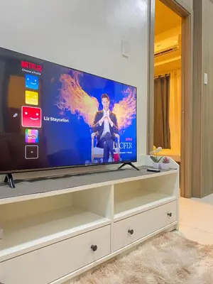 a flat screen tv sitting on top of a dresser at 1BR Cozy Minimalist Unit near MOA or Manila Bay in Manila