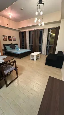a living room with a couch and a table at GambinoAirbnb in Manila