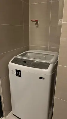 a stove top in a kitchen with a tile wall at GambinoAirbnb in Manila